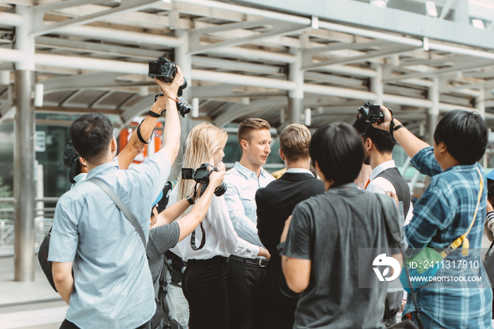 business man important press release surrounded scramble with reporters newspaper journalist photographer