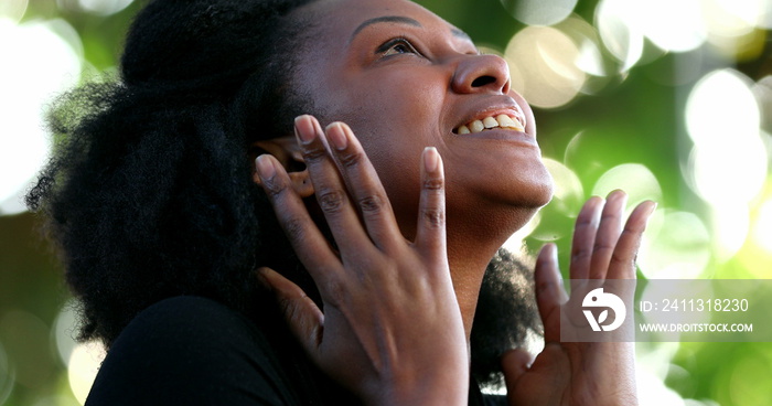 African woman feeling hopeful and spiritual. Faithful person having HOPE and FAITH