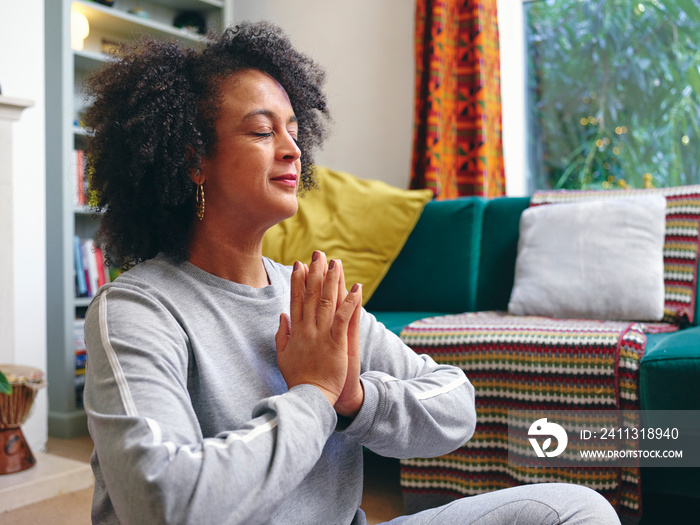 Woman practicing yoga at home