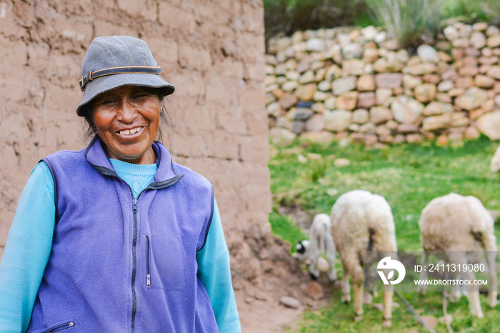 Happy native american farmer with her sheep in the countryside.