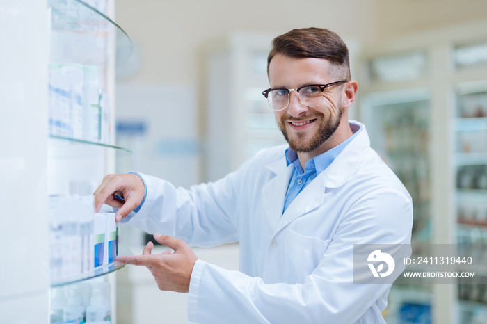 Positive delighted brunette apothecary looking at camera