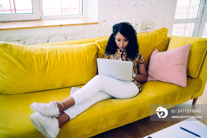 Black student using laptop at home