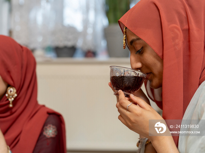 Woman drinking tea during Ramadan celebration at home