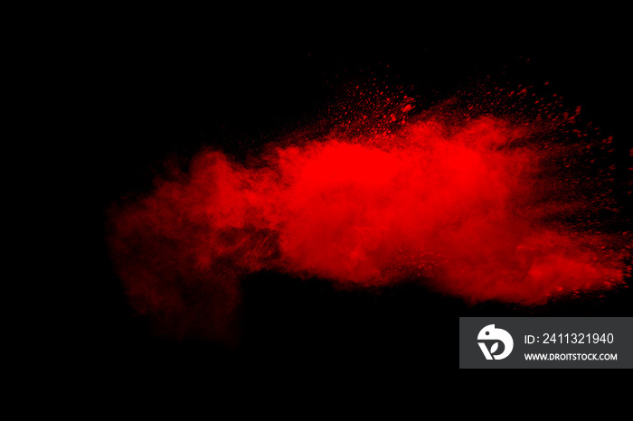 Abstract red dust explosion on black background. Freeze motion of red powder splash.