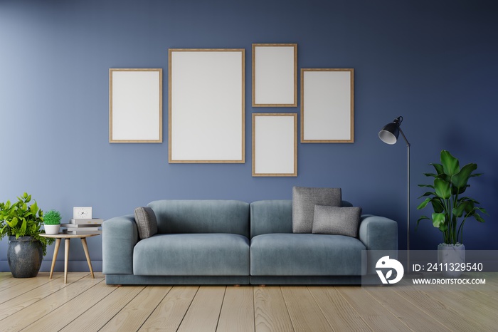 Poster mockup with vertical frames on empty dark wall in living room interior ad dark blue sofa.