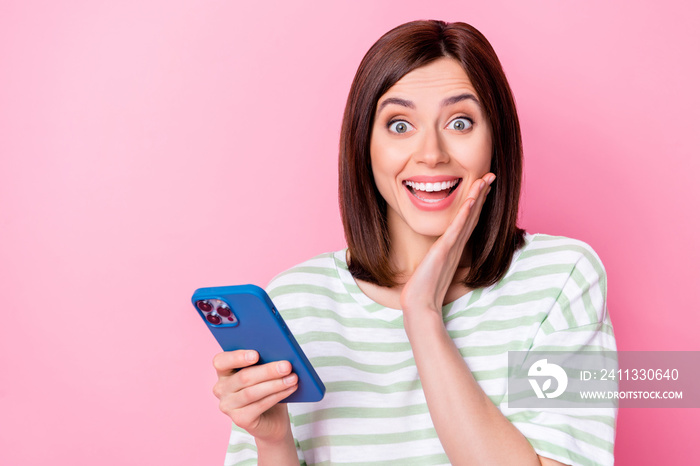 Portrait of adorable pretty lady hand touch face hold gadget satisfied modern technology empty space isolated on pink color background