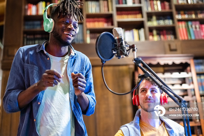 young artist singer African American rapper performs during a web radio broadcast, live streaming organized in home environment with modern technological equipment