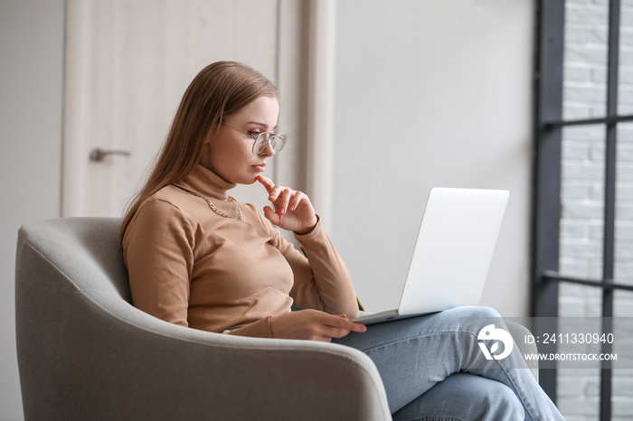 Female psychologist video chatting with patient on laptop at home