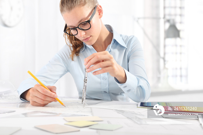 interior designer draws at desk in office, with pencil and compass, Planning Concept