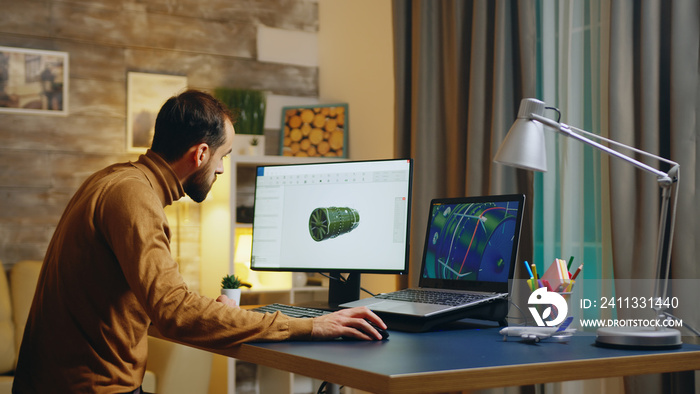 Young engineer in his home office working on developing a new turbine