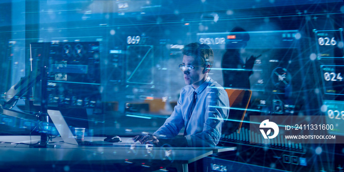 man working on computer in dark office