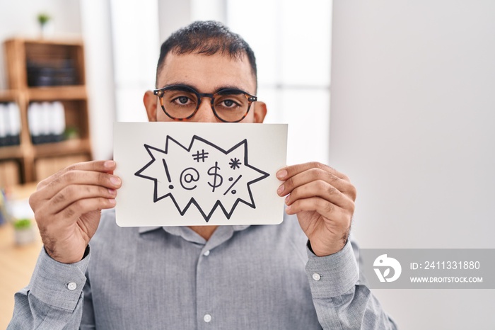 Middle east man with beard holding banner with swear words puffing cheeks with funny face. mouth inflated with air, catching air.