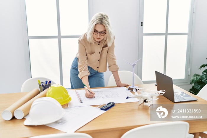 Young caucasian woman working at architect studio