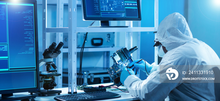 African-American scientist works in a modern scientific laboratory for the research and development of microelectronics and processors. Manufacturing worker uses computer technology and equipment.