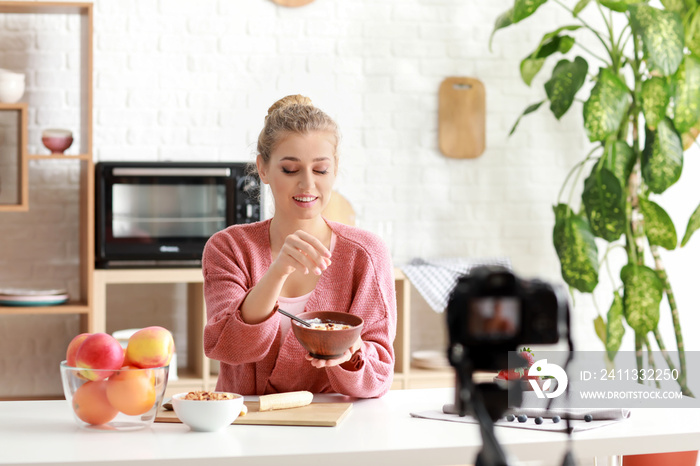 Young female food blogger recording video indoors