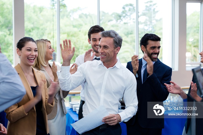 Happy business executives giving high five