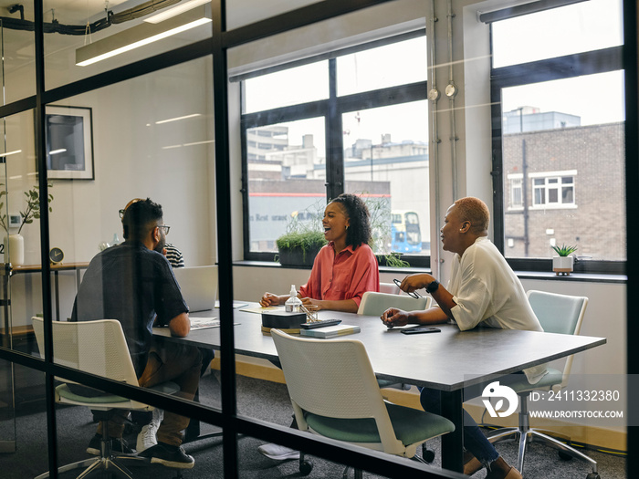 Colleagues talking at business meeting