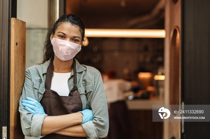 Woman cafe owner with face mask