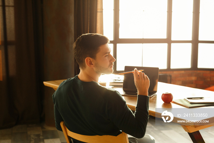 Young Entrepreneur Thinking Holding Pencil Working Sitting At Workdesk Indoors