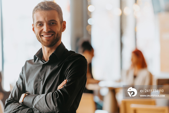 Cheerful self confident professional businessman with crossed hands portrait.