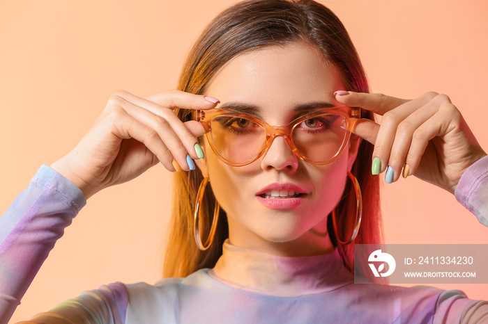 Young woman with beautiful manicure on color background