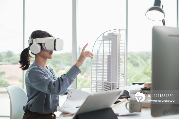 Technology futuristic virtual reality design. Architect or Engineer female wearing VR headset in office.