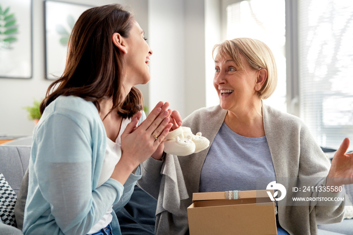 Excited woman informs mom that she will become a grandmother