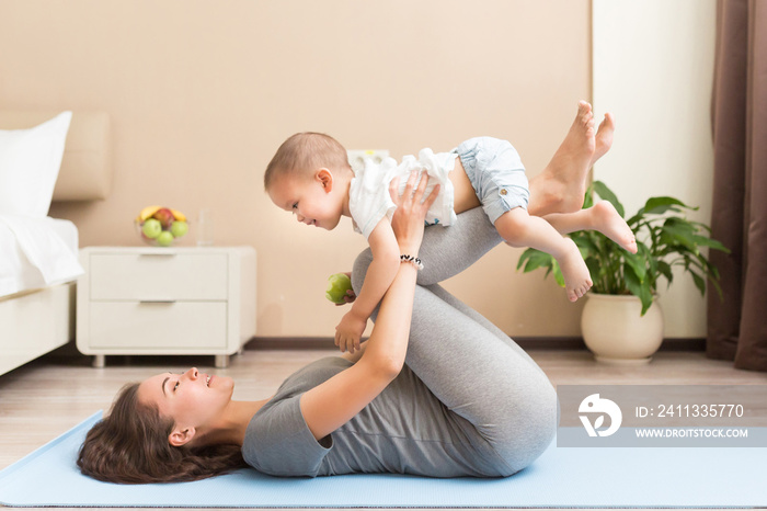 Health concept. Young beautiful pregnant woman does yoga exercise in the modern room