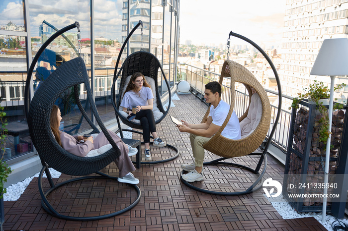 Three business colleagues are talking on terrace of business center