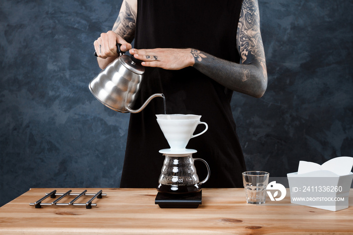 Male barista brewing coffee. Alternative method pour over.