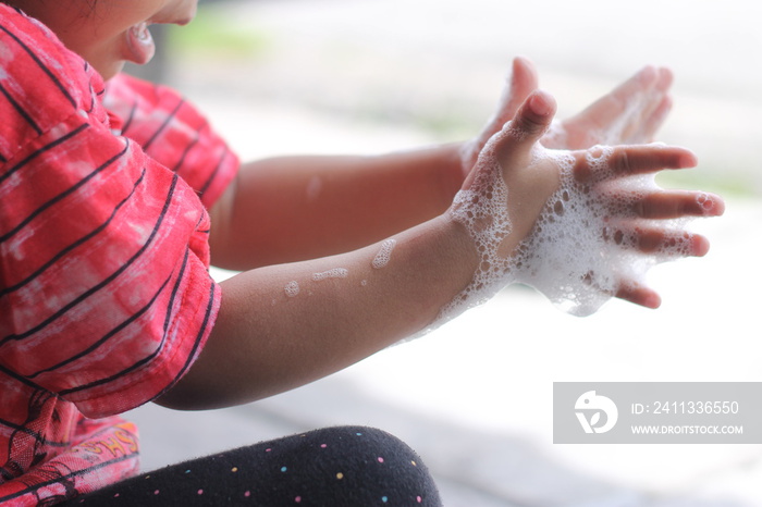 cute girl washing her hand and playing with buble. Selective focus