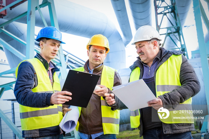 Engineers discussing maintenance of a petrochemical plant