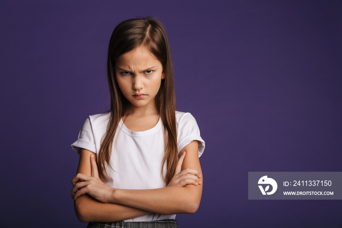 Photo of angry beautiful girl posing with hands crossed on camera