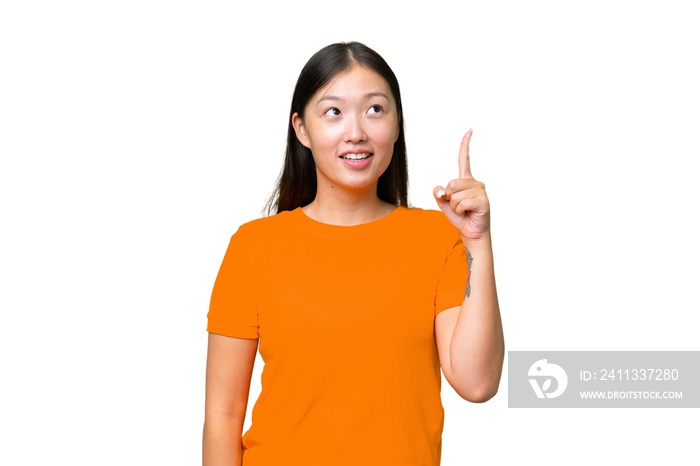 Young Asian woman over isolated background having doubts while looking side
