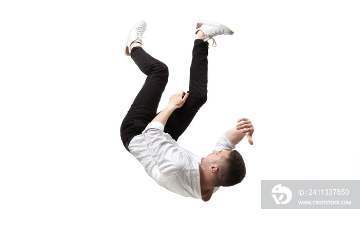 Mid-air beauty cought in moment. Full length shot of young man hovering in air and keeping eyes closed. Levitating in free falling, lack of gravity, flying. Freedom, emotions, artwork concept.