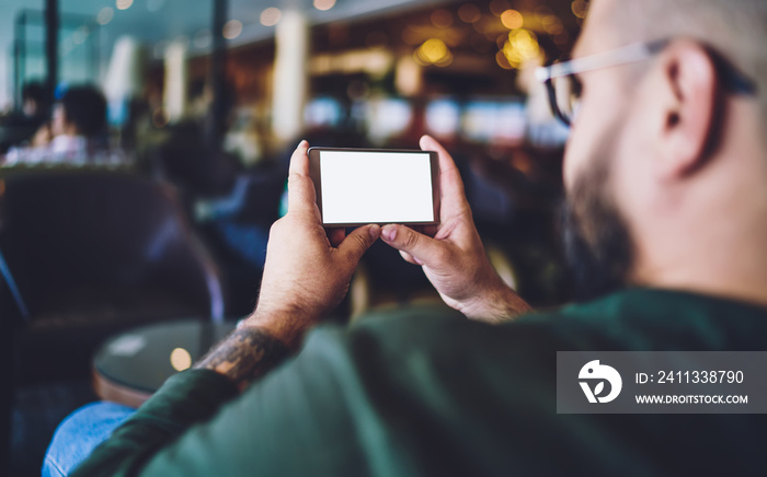 Bearded man using smartphone for watching video