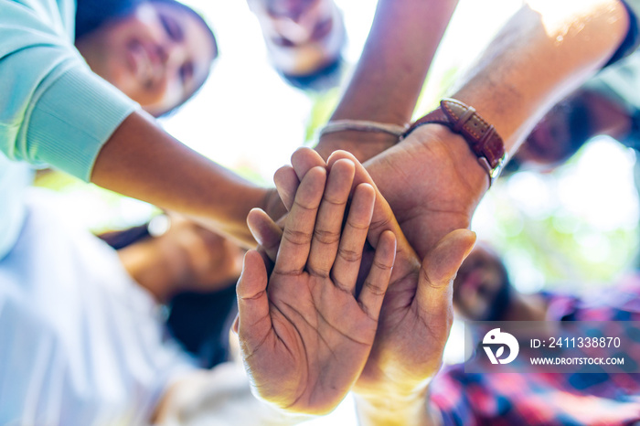 Diverse of big group of peoples hands together outdoors