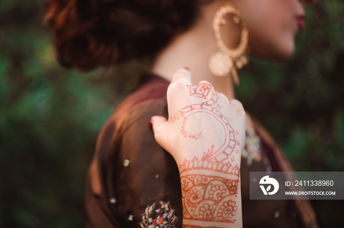 Mehndi covers hands of Indian woman