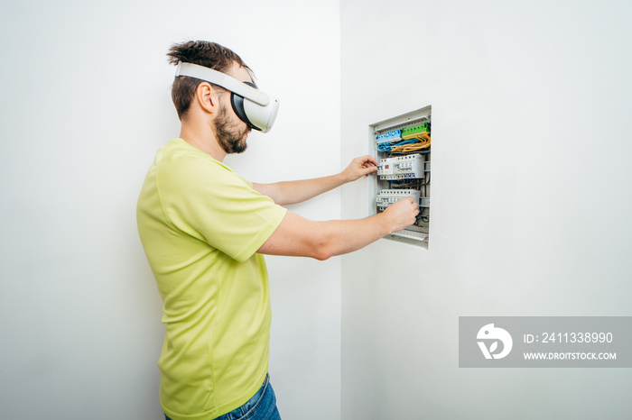 Young bearded man using virtual reality goggles before starting renovations in his townhouse