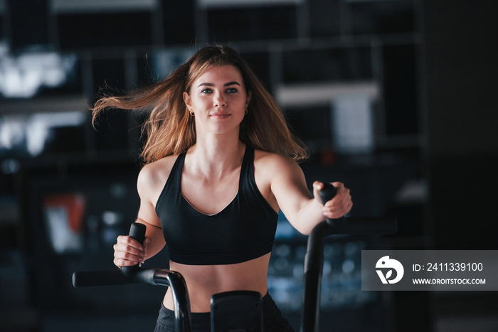 Flying hair. Photo of gorgeous blonde woman in the gym at her weekend time