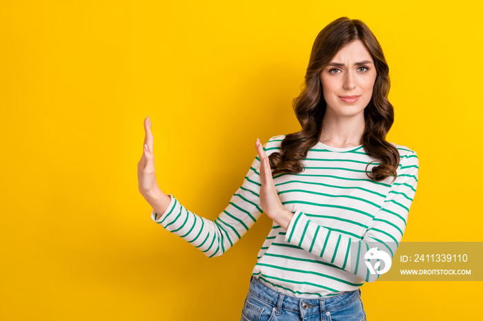 Photo of nice girlish woman with curly hairstyle wear striped shirt hold palms deny proposition isolated on yellow color background