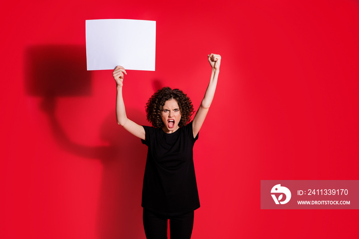 Portrait of beautiful hairdo attractive girl scream against hold paper arm up black t-shirt isolated on red color background