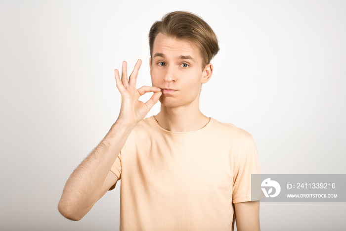 Mouth shut guy seal lips showing taboo don’t speak on a white background.