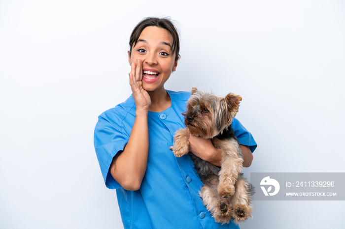 Young veterinarian woman with dog isolated on white background shouting with mouth wide open