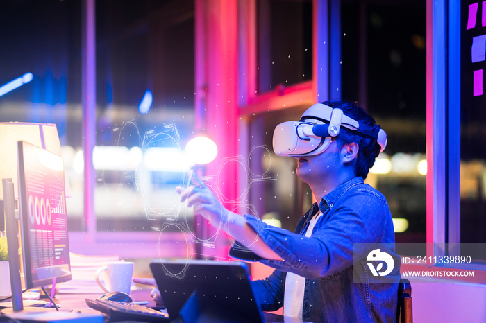 asian young male wearing wearable goggle headset virtual online meeting digital space working with 3d augmented dimension at home,cyber virtual working with virtual vr goggle and pc desktop device