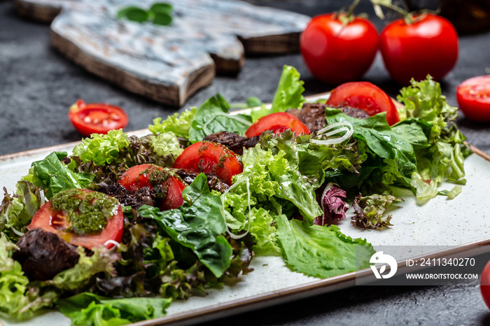 Salad with chicken liver. Fresh vegetable salad. Meat salad with liver, salad leaves, cheese, tomatoes on plate. Diet menu. Top view