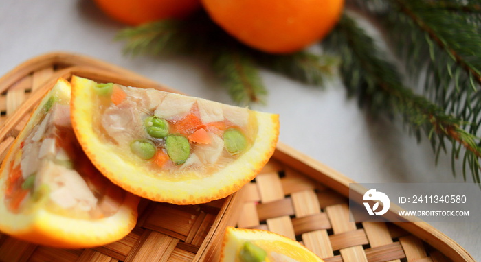 appetizer of jellied chicken with vegetables in orange close up selective focus