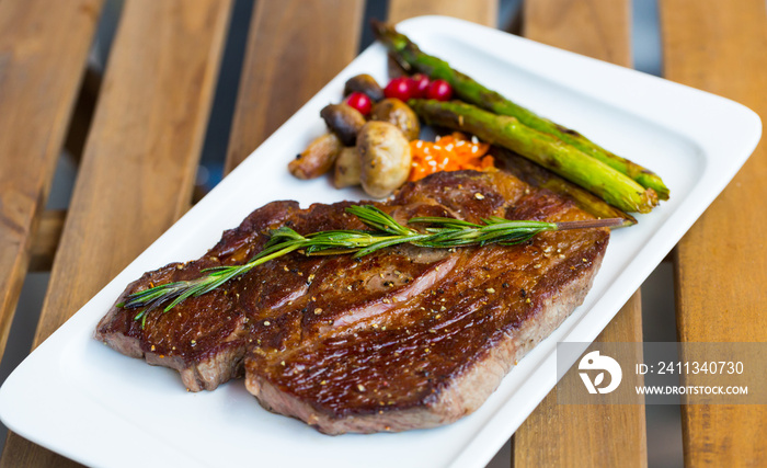 Fried steak entrecote of beef with mushroom and asparagus at plate