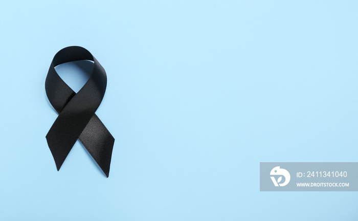 Black ribbon on blue background. Melanoma concept