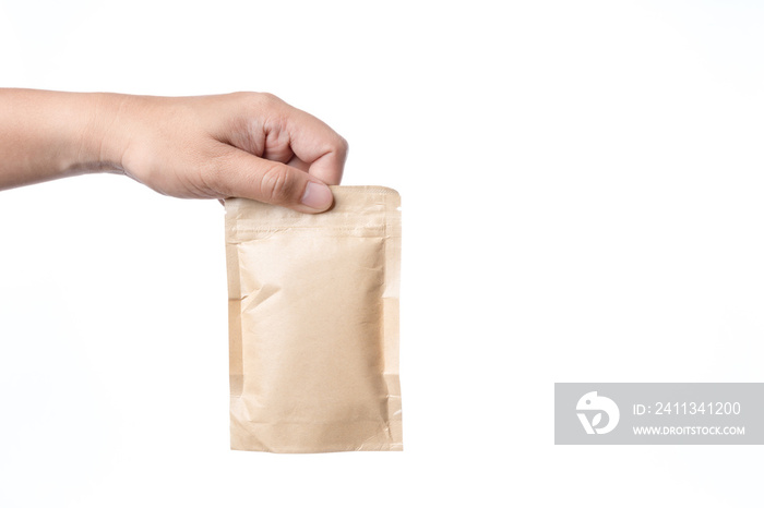 Hand holding brown paper packaging bag with zipper lock